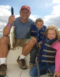 Beau with two children and a fish